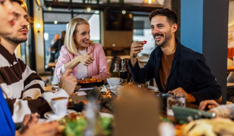 A group of friends eating a meal together at a pub